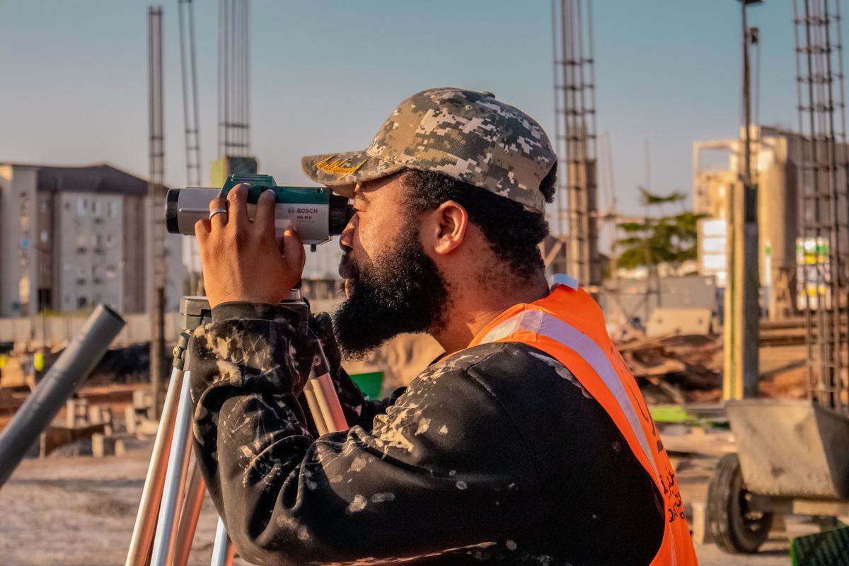 Surveyor sighting through a total station